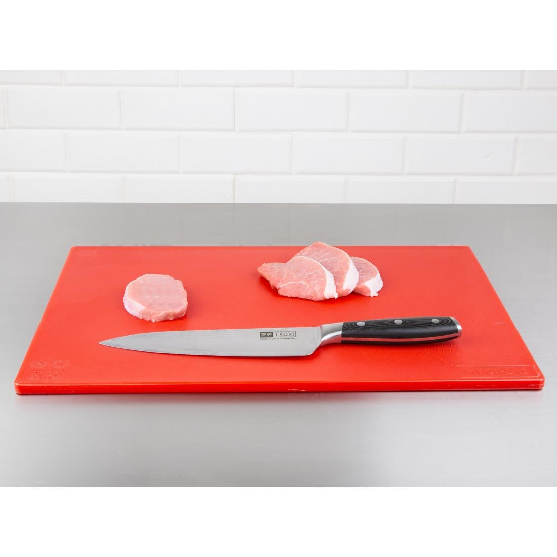 Hygiplas Low Density Red Chopping Board Standard with knife and cut meat.