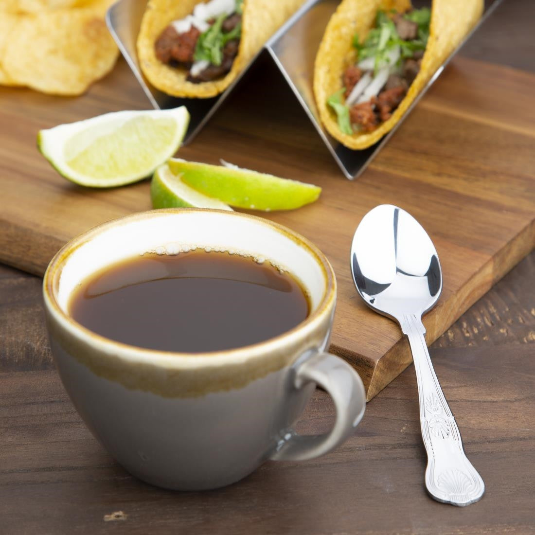 Cup with content and Olympia Kings Teaspoon placed on the side.