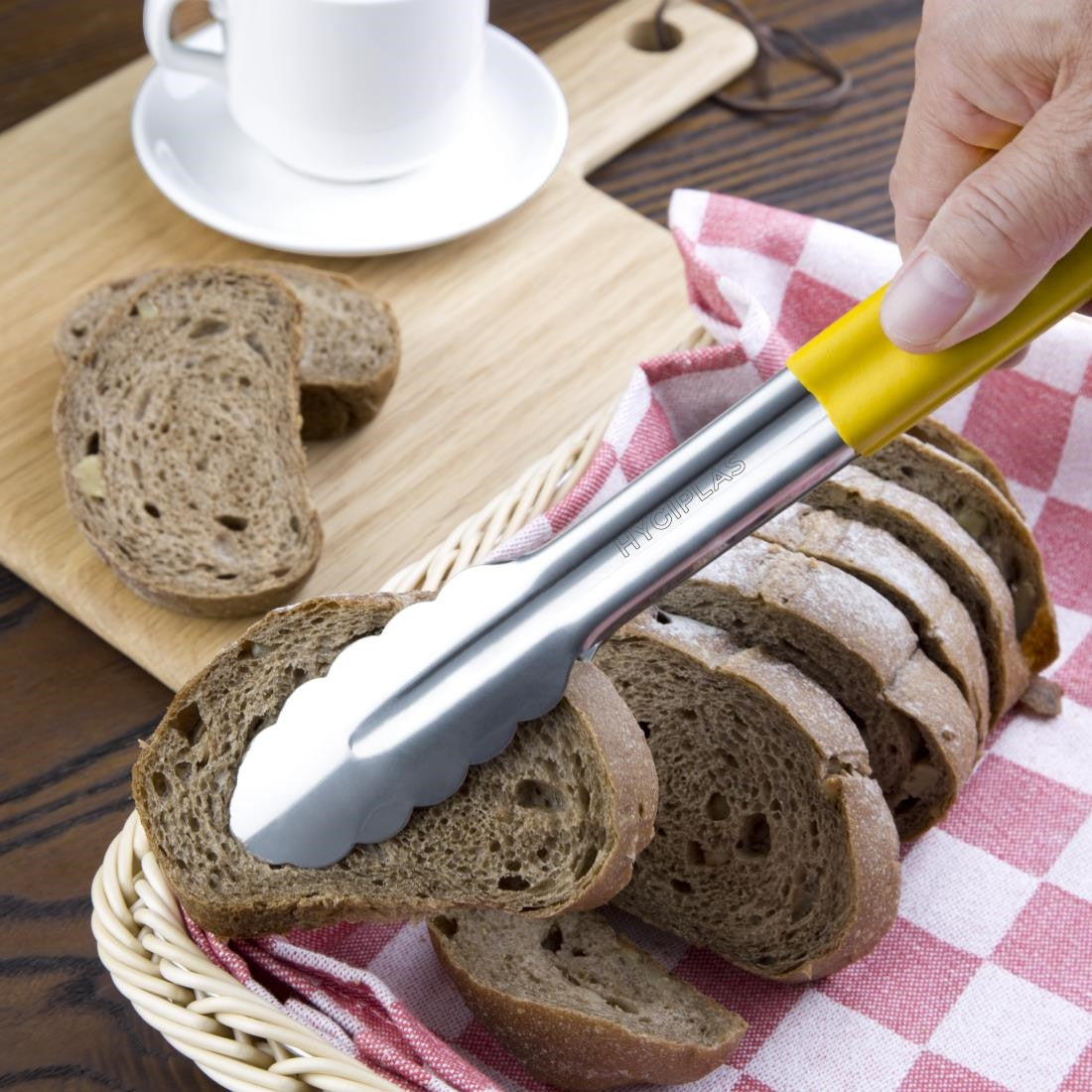 Hygiplas Colour Coded Yellow Serving Tongs 11" use to pick up bread.