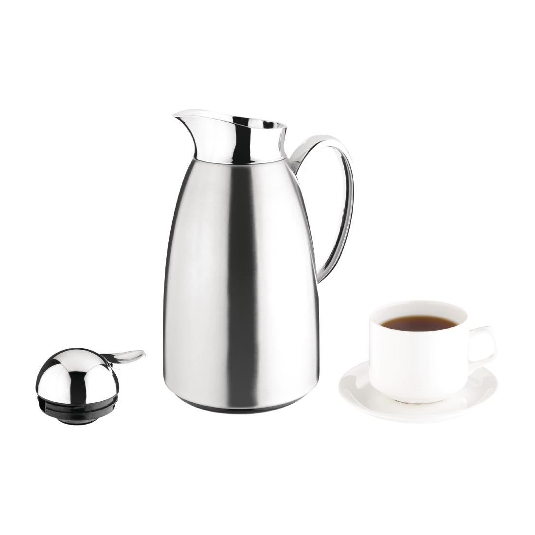 Olympia Vacuum Insulated Jug 1Ltr with lid on the table and cup of coffee and saucer.