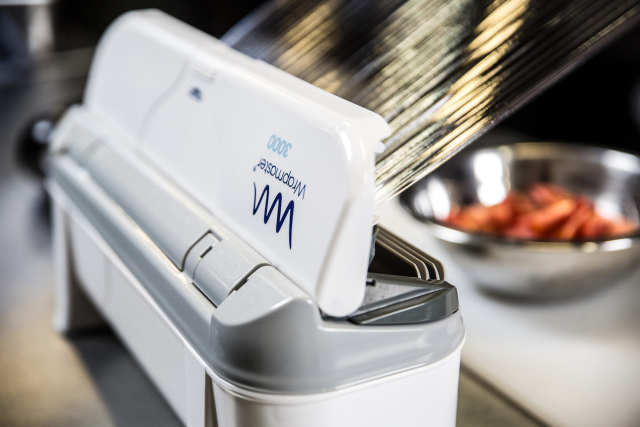 Wrapmaster Dispenser 3000 dispensing roll in a buffet setting