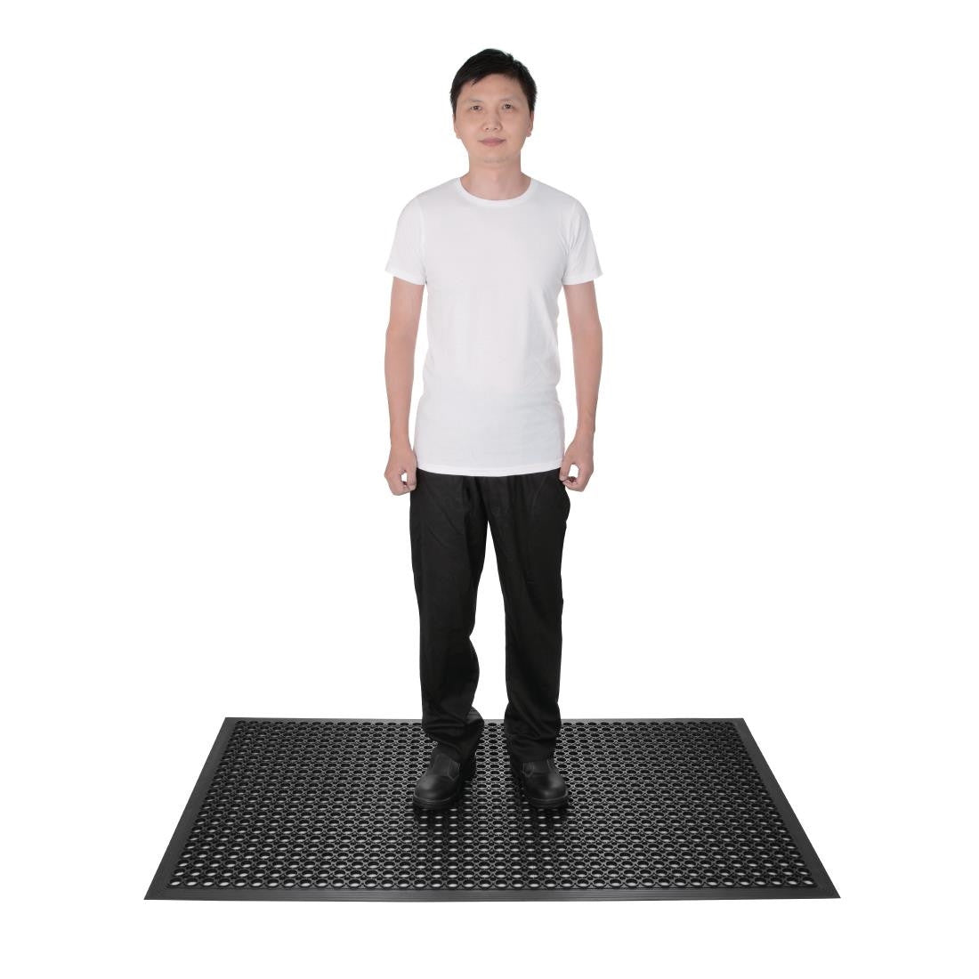 Man standing on Black Jantex Rubber Anti Fatigue Mat.