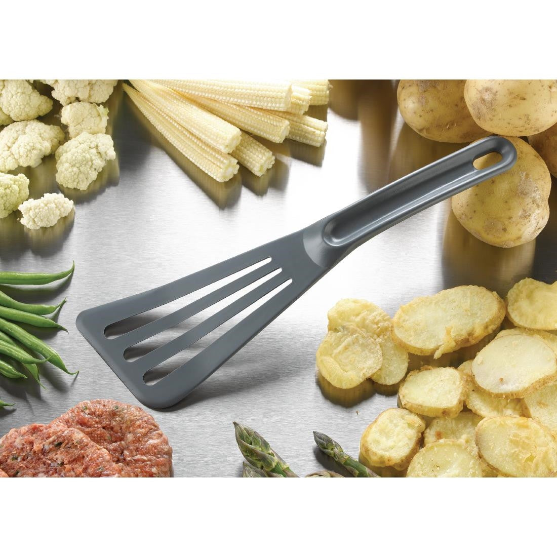 Matfer Bourgeat High Heat Spatula placed between vegetables and meat.