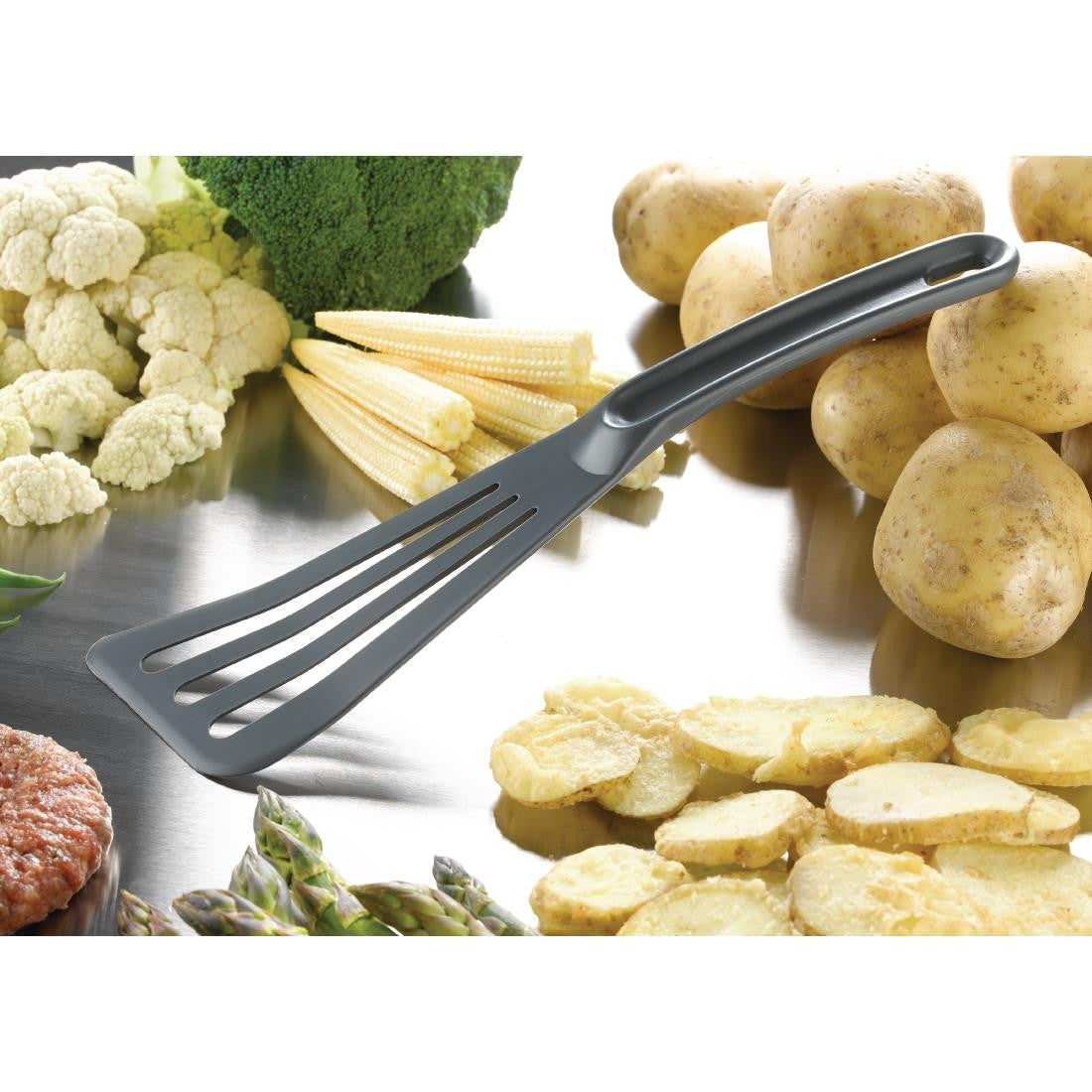 Matfer Bourgeat High Heat Spatula placed between vegetables and meat.