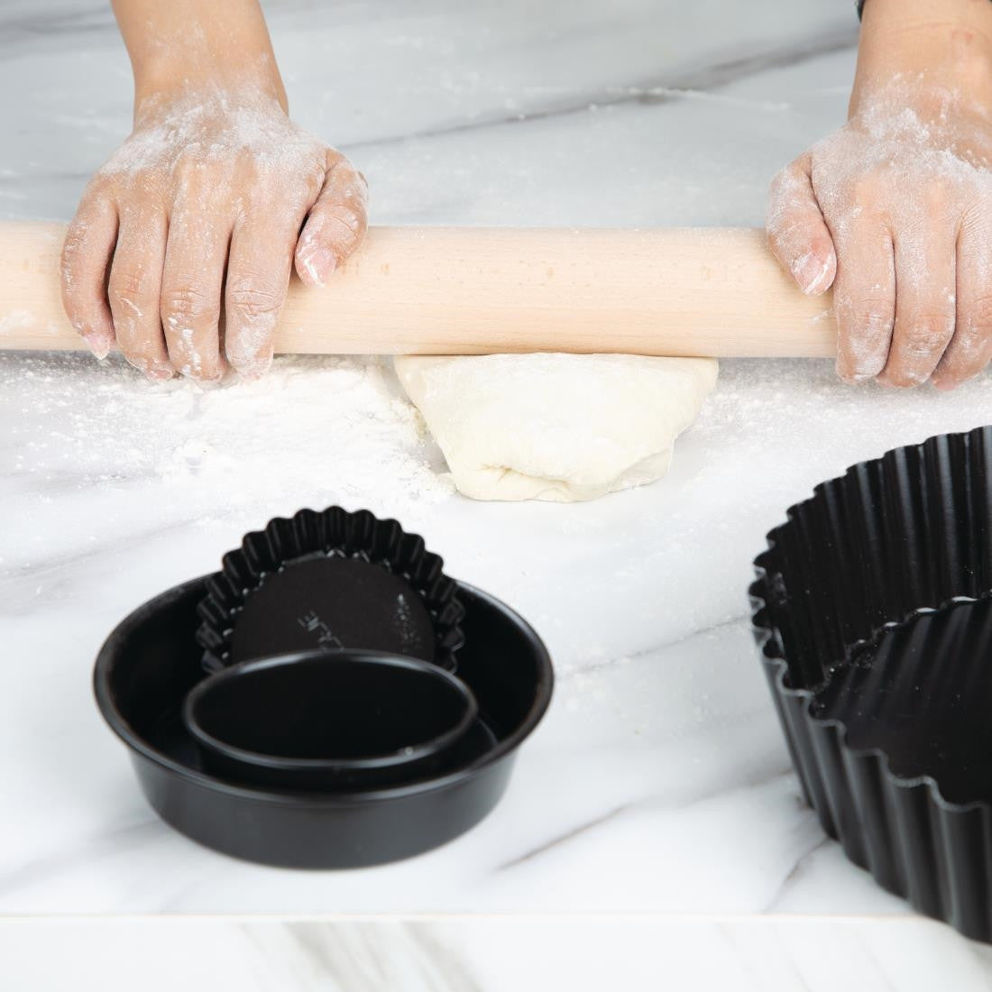 Vogue Wooden Rolling Pin 18"  used to flatten the dough.