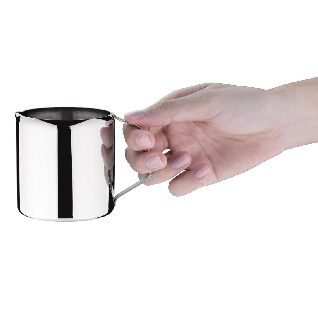 Olympia Concorde Stainless Steel Milk Jug 285ml in hand.