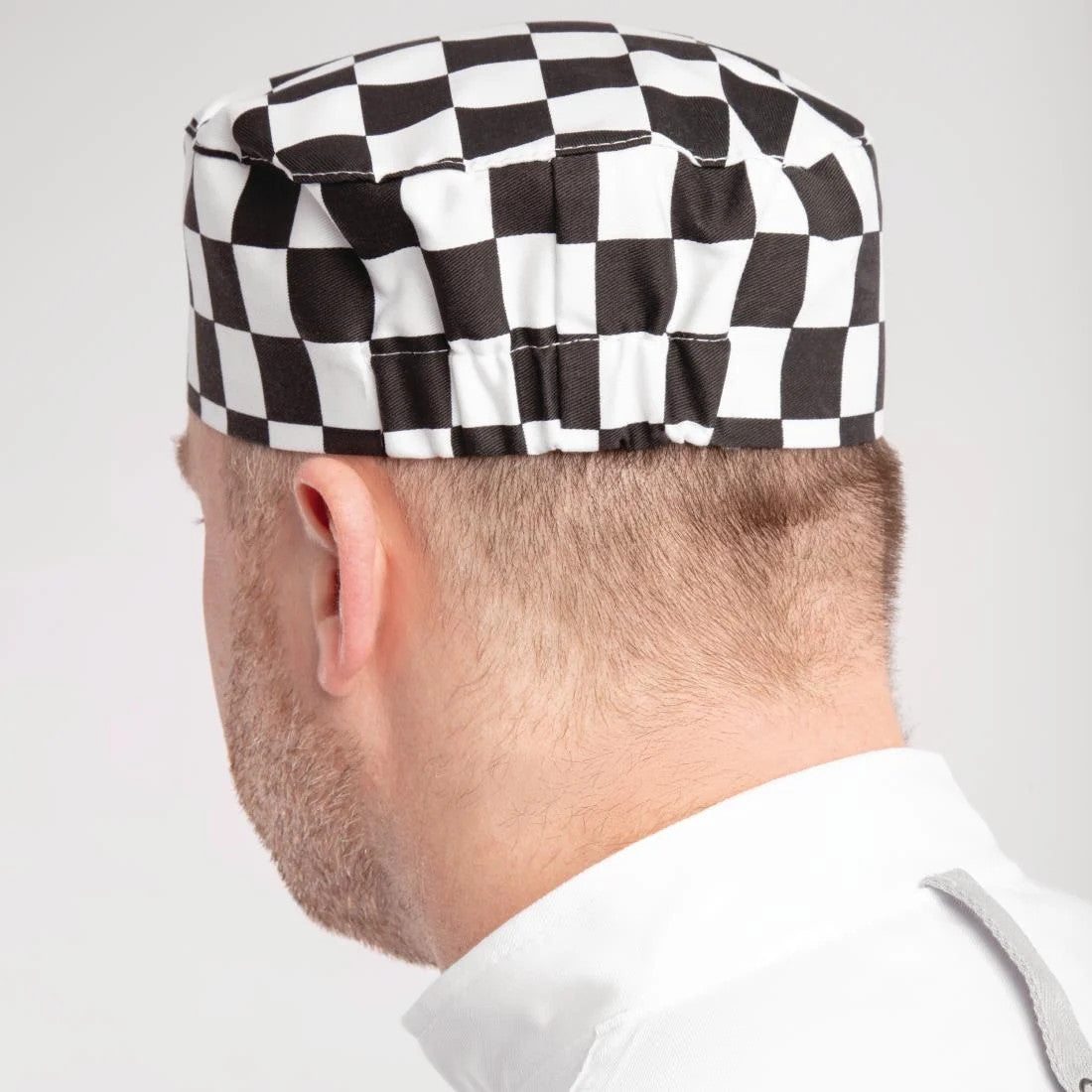 Back of Chef wearing Whites Chefs Skull Cap Big Black and White Check